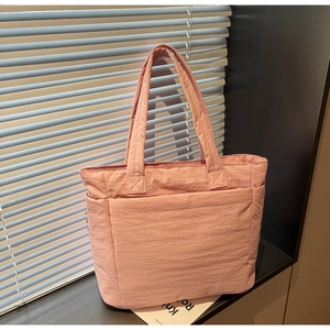 Chic pink quilted nylon tote bag with spacious main compartment and wide shoulder straps