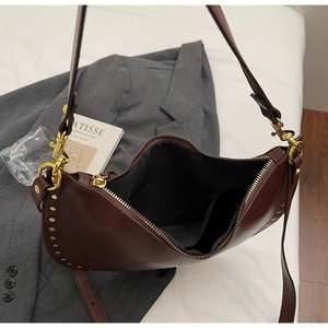 Internal view of brown hobo bag with gold rivets and black inner storage pocket