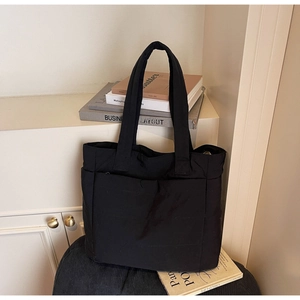 Fashionable black quilted nylon tote bag with functional pockets for daily commuting