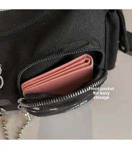 Detail of canvas bag front pocket featuring silver zipper and functional storage space