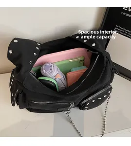 Detail view of canvas punk bag with silver studs showing large storage capacity