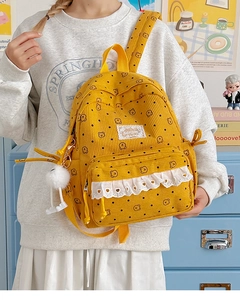 Close-up of yellow corduroy backpack featuring bear prints and white lace detail
