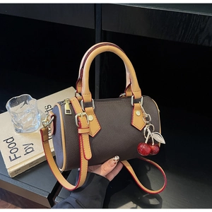 Classic monogram brown Boston barrel bag with red edges and a cherry charm detail