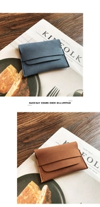Detail of matte suede coin purses in grey-blue and tan with fine stitching and flap closure