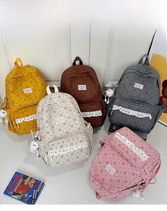 Detailed display of corduroy backpacks with cute bear prints in five diverse colors