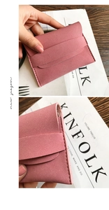 Close-up of dusty pink suede envelope wallet with fine stitching and slim strap detail