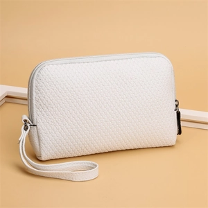 Detail of white textured PU leather clutch bag with wrist strap and metal zipper