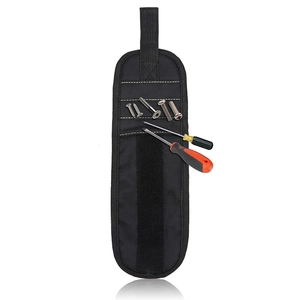 Detail of magnetic wristband with attached screws and screwdrivers for tool storage