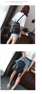Classic black nylon backpack with golden zipper detail shown in lifestyle use