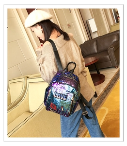 Detailed close-up of colorful gradient sequins and LOVE lip embroidery on the backpack