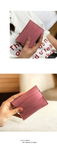 Close-up of matte pink leather card holder showing multiple slots and slim design