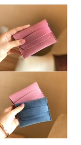 Detail view of pink and blue matte suede mini envelope coin purses with neat stitching