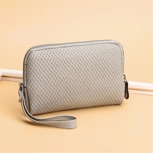 Gray quilted PU leather clutch bag with wristlet strap and minimalist zipper closure