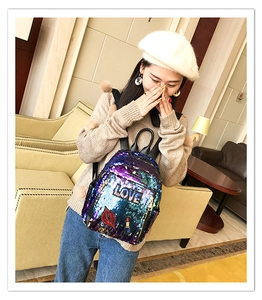 Detail of sequin backpack with LOVE patch and embroidered lips for casual style