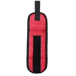 Detail of red magnetic wristband showing nylon fabric texture and velcro strap