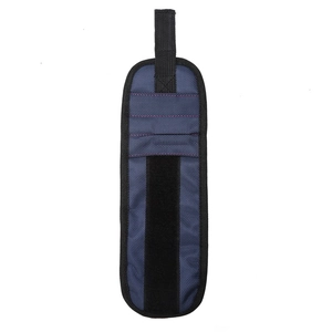 Detail of a navy blue nylon magnetic tool wristband with strong velcro and red stitching