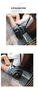 Detail of minimalist black nylon backpack with high-quality gold metal zipper accents