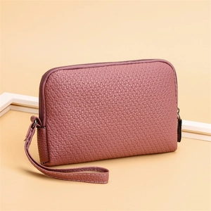 Detailed macro view of litchi textured dusty rose PU leather pouch with metal zipper