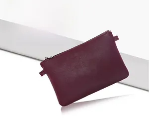 Detail view of burgundy leather textured rectangular clutch with premium metal zipper