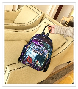 Detailed close-up of gradient sequins and colorful lip embroidery on a fashion backpack