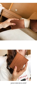 Detail of a brown matte suede mini envelope wallet with wavy multi-slot card holder design
