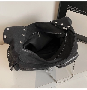 Top view of the spacious black canvas interior and silver metal zipper of the biker bag