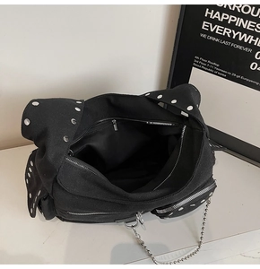 Detailed interior view of a black studded motorcycle tote bag with large storage space