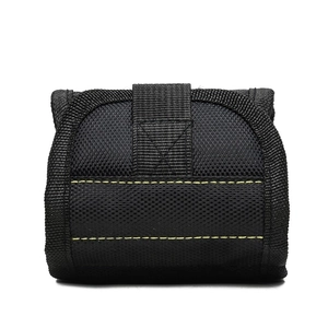 Detail of magnetic tool wristband with black tactical nylon texture and yellow stitching