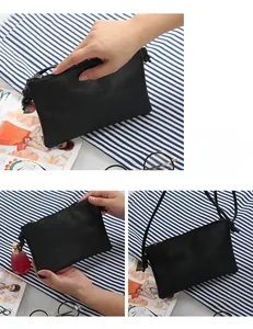 Detail of minimalist black litchi texture square handbag with zipper and shoulder strap