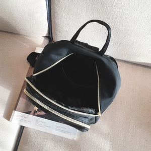 Modern black nylon multi-compartment backpack with gold zippers and spacious interior design
