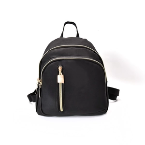 Minimalist black nylon backpack for women with gold zippers and multi-pocket design