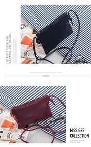Close-up of minimalist crossbody bags in navy and burgundy with litchi texture