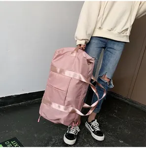Detailed view of pink waterproof oxford travel bag with reinforced straps and metal D-rings