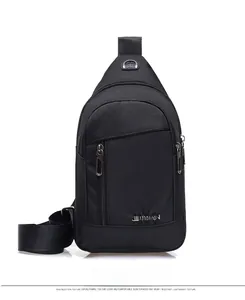 Detail view of black oxford fabric sling bag with vertical zipper and sport logo
