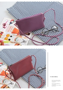 Detailed macro shot of purple and burgundy PU leather mini crossbody bags with top zipper