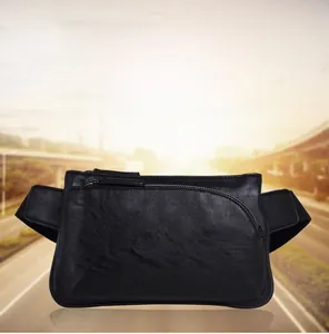 Detail of black pebbled leather waist bag showing the main zipper and front pocket