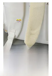 Close-up of wide ergonomic S-shaped straps with breathable mesh on white backpack