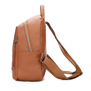Side view of caramel brown washed PU leather backpack showing silver zippers and side pocket