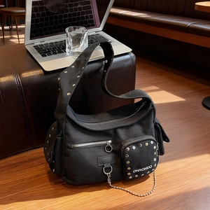 Black rivet motorcycle crossbody bag with silver chains and functional pockets