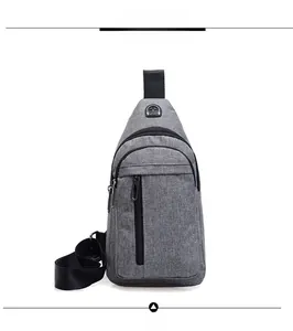 Detail view of grey canvas crossbody bag with headphone port and embroidered logo