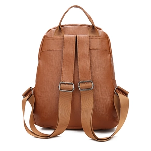 Detail view of brown washed PU leather backpack straps and silver metal buckles