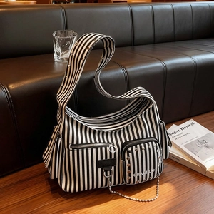 Black and white striped canvas hobo bag with silver rivets and metal chain decoration