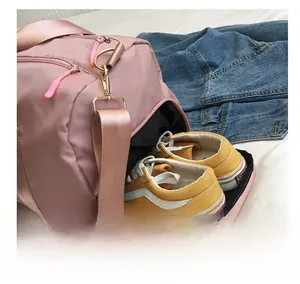 Pink waterproof Oxford travel bag detail showing the separate shoe compartment with sneakers
