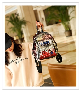 Detail of sequins backpack with LOVE patch, red lip embroidery and black PU handle