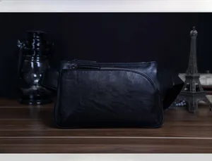 Close-up of black textured leather waist bag featuring front zipper and adjustable strap