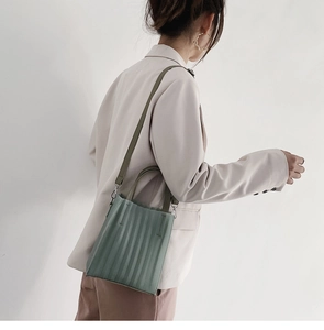 Vue détaillée du sac plissé vert Morandi avec des boucles élégantes en métal doré
