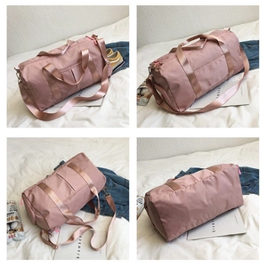 Detail view of pink waterproof oxford travel bag featuring a separate shoe compartment