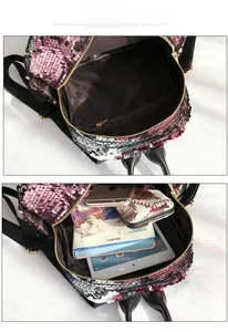 Internal view of pink glitter backpack showing storage for tablet and notebook
