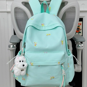 Mint green school backpack with colorful bow embroidery and cute plush puppy charm