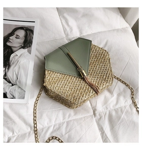 Detail of hexagonal straw crossbody bag with sage green leather flap and gold chain